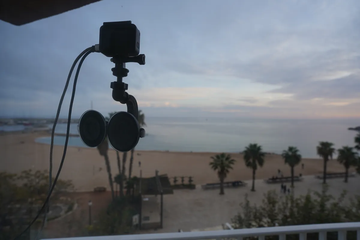 Professional recording equipment set up on a beach at sunset